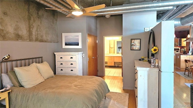 bedroom with a high ceiling and ensuite bathroom