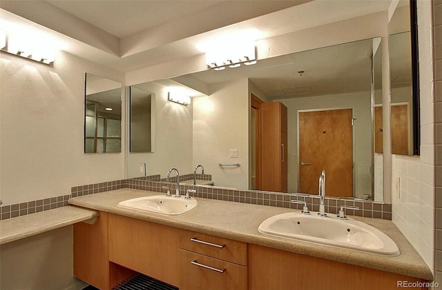 bathroom with vanity and decorative backsplash