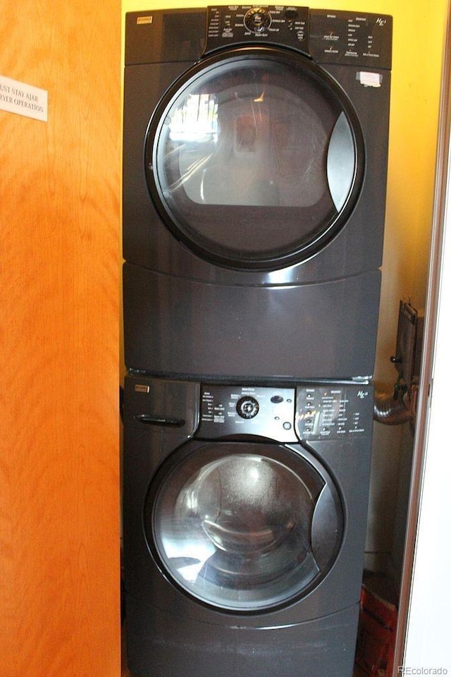 washroom with stacked washer / dryer