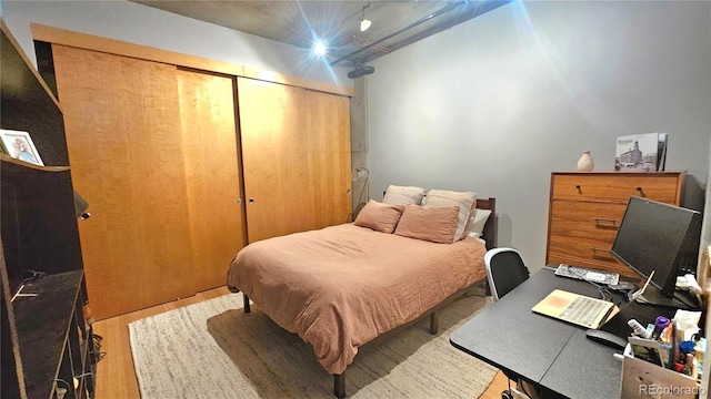 bedroom featuring hardwood / wood-style floors and a closet