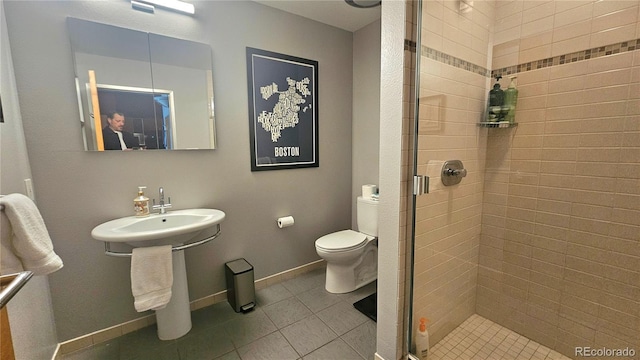 bathroom with toilet, tile patterned floors, and walk in shower