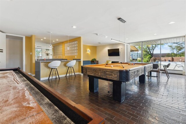 4570 E Yale Ave Unit 706, Denver, CO 80222 - recreation room featuring recessed lighting, brick floor, a wealth of natural light, and pool table