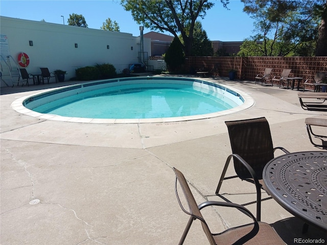 4570 E Yale Ave Unit 706, Denver, CO 80222 - view of pool with a patio area, a fenced in pool, and fence