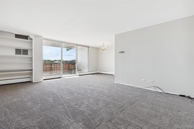 carpeted empty room with baseboard heating and a chandelier