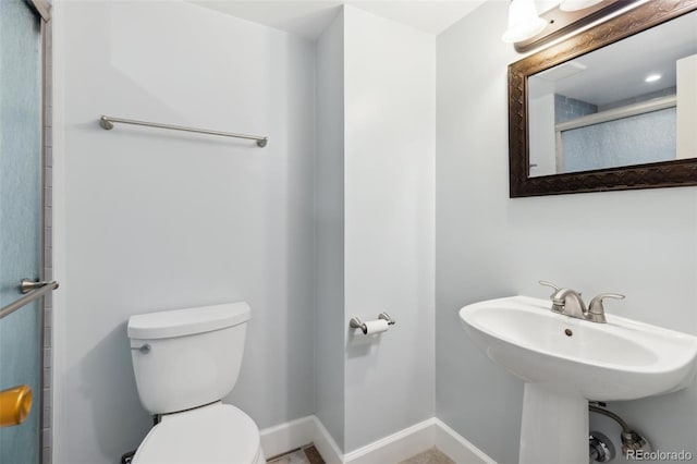 bathroom with toilet and walk in shower