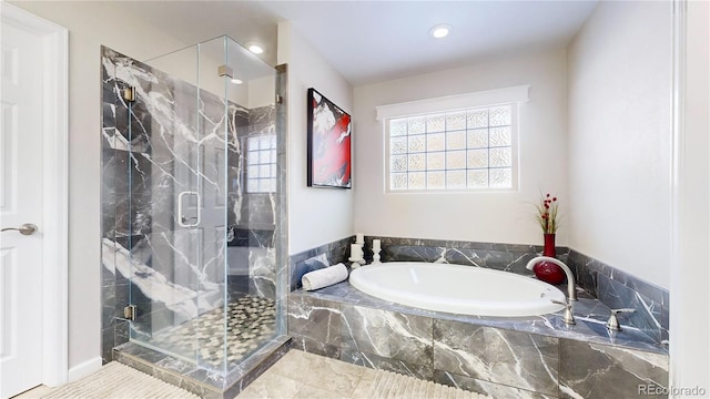 bathroom with a garden tub and a shower stall