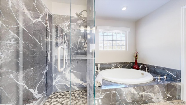 bathroom with a marble finish shower and a bath