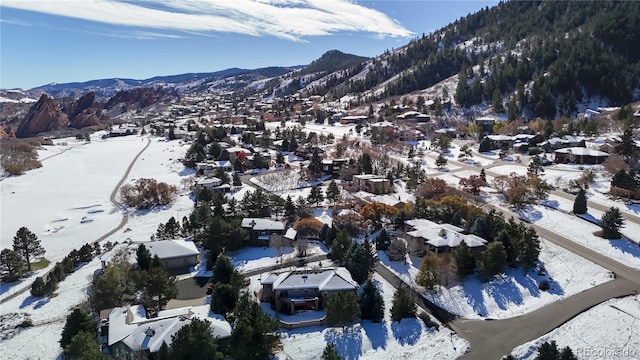 snowy aerial view featuring a mountain view