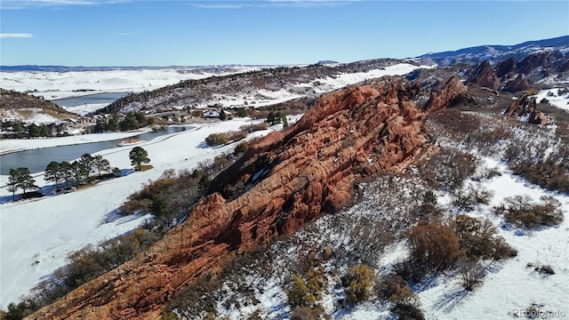 snowy aerial view with a mountain view