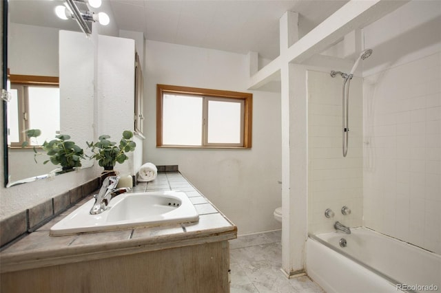 full bath featuring toilet, vanity, and bathing tub / shower combination