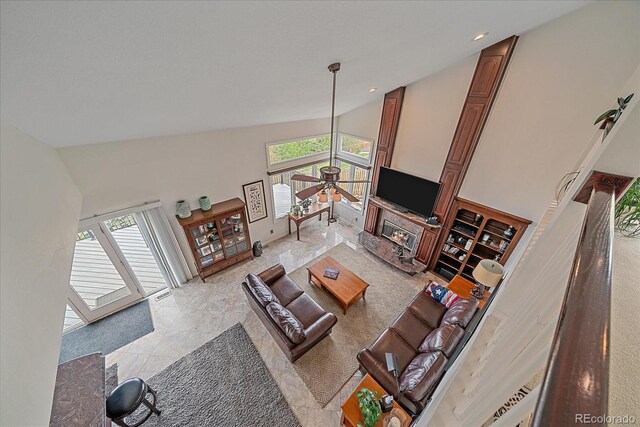living area featuring high vaulted ceiling, a ceiling fan, and a wealth of natural light