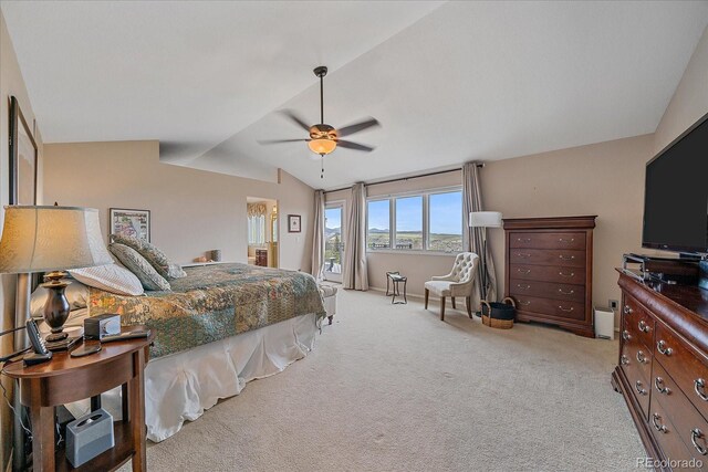 bedroom with ceiling fan, vaulted ceiling, and light colored carpet