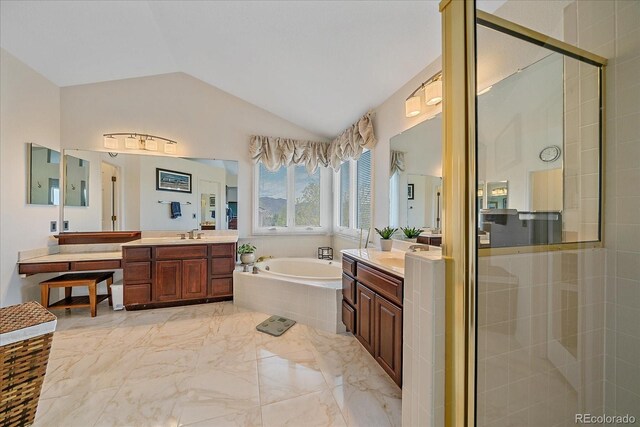 bathroom featuring a bath, a shower stall, two vanities, marble finish floor, and lofted ceiling