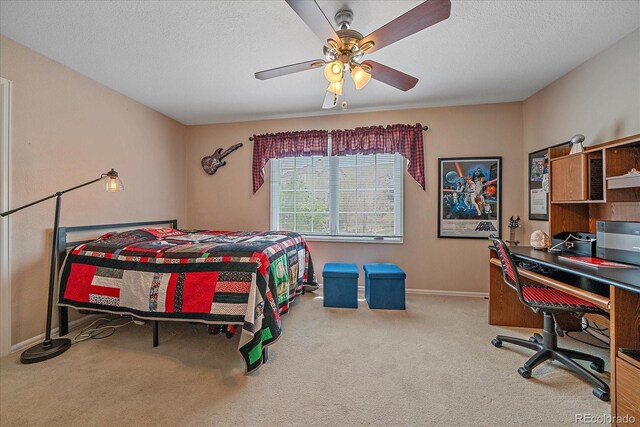 carpeted bedroom with baseboards, a textured ceiling, and ceiling fan