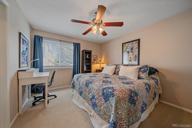 bedroom featuring carpet floors, a textured ceiling, baseboards, and a ceiling fan