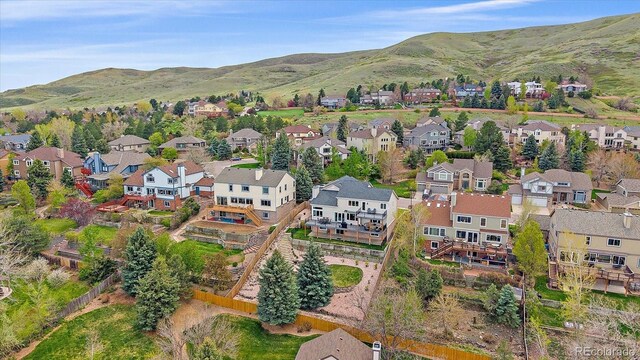 drone / aerial view featuring a residential view and a mountain view