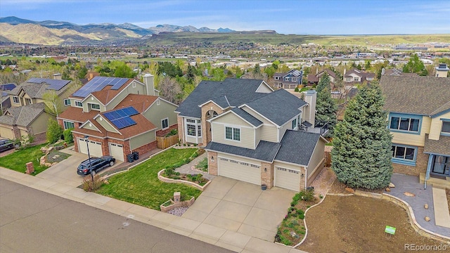 birds eye view of property with a mountain view and a residential view