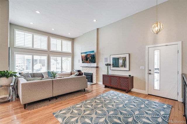 living room featuring hardwood / wood-style floors, a chandelier, and a high ceiling