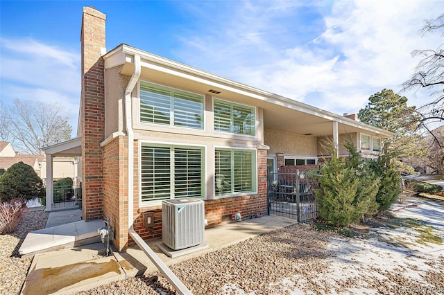 rear view of property with cooling unit