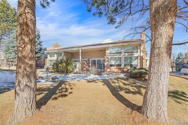 rear view of property featuring a yard