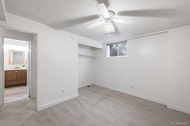 12648 W Virginia Ave, Lakewood, CO 80228 - unfurnished bedroom with ceiling fan, light colored carpet, a sink, a textured ceiling, and a closet