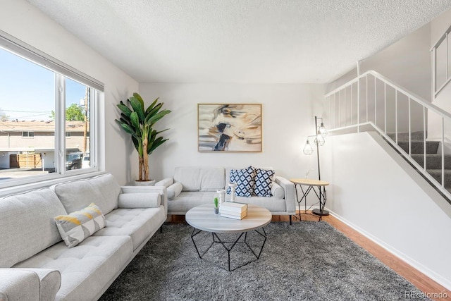 12648 W Virginia Ave, Lakewood, CO 80228 - living room with stairway, a textured ceiling, baseboards, and wood finished floors