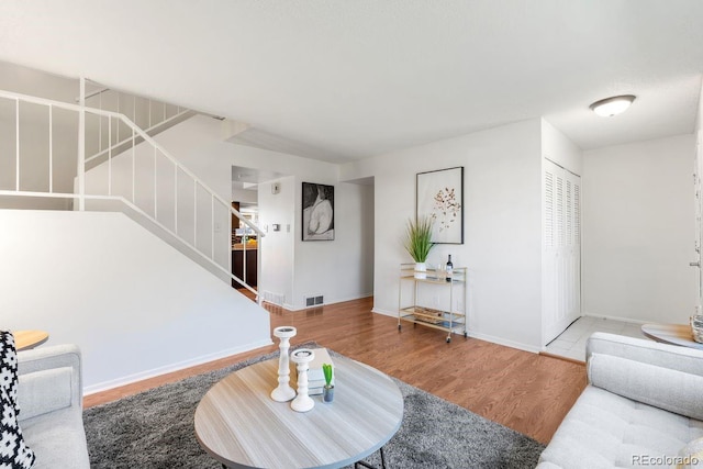 12648 W Virginia Ave, Lakewood, CO 80228 - living room with baseboards, stairs, wood finished floors, and visible vents