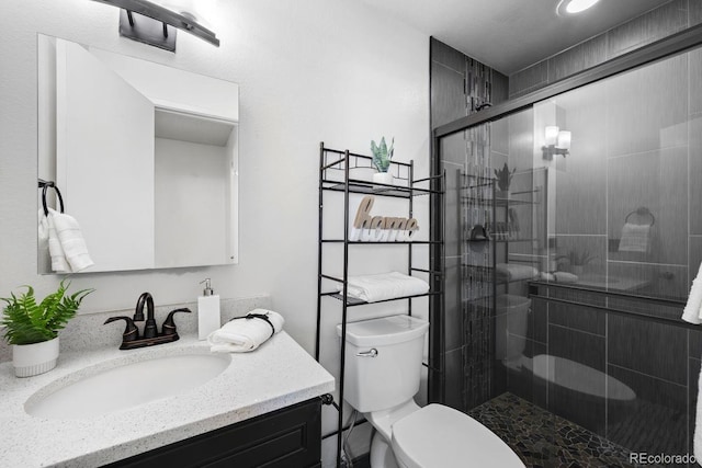 12648 W Virginia Ave, Lakewood, CO 80228 - bathroom featuring vanity, a stall shower, and toilet