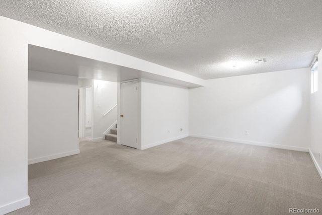 12648 W Virginia Ave, Lakewood, CO 80228 - finished below grade area with stairway, baseboards, a textured ceiling, and light colored carpet