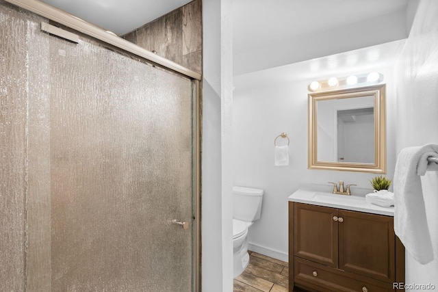 12648 W Virginia Ave, Lakewood, CO 80228 - bathroom featuring vanity, baseboards, a shower stall, and toilet