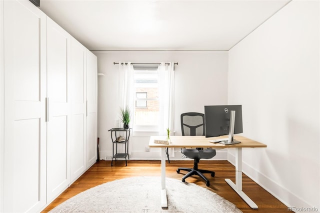 home office featuring baseboards and light wood finished floors