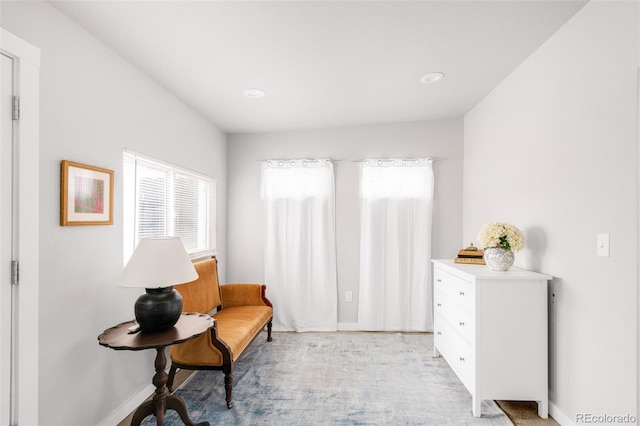 living area featuring a wealth of natural light, baseboards, and light wood-style floors