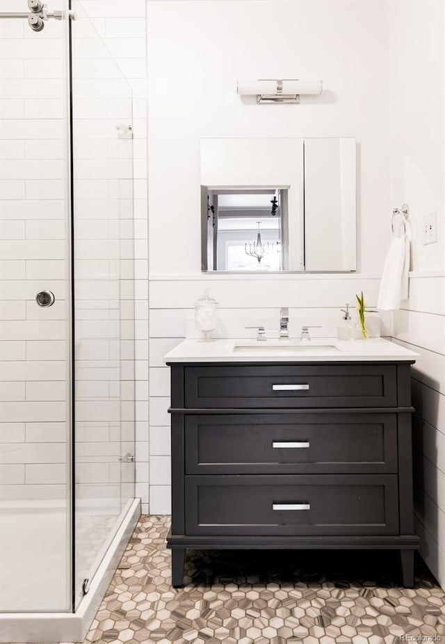 full bath with a stall shower and vanity