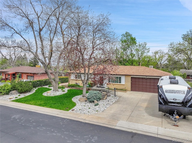 ranch-style home with concrete driveway and an attached garage