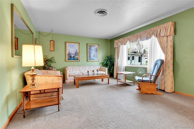 sitting room featuring baseboards, visible vents, and carpet