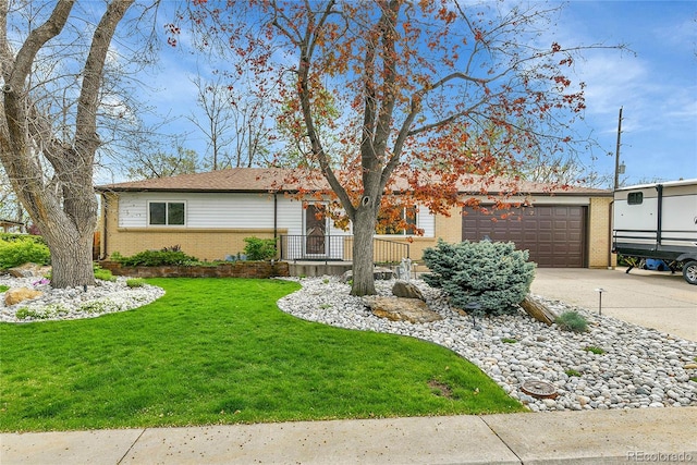single story home with concrete driveway, brick siding, a garage, and a front lawn