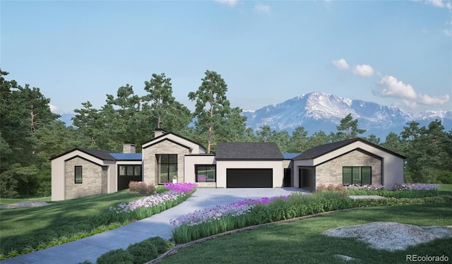 view of front facade featuring a mountain view, solar panels, a garage, and a front yard