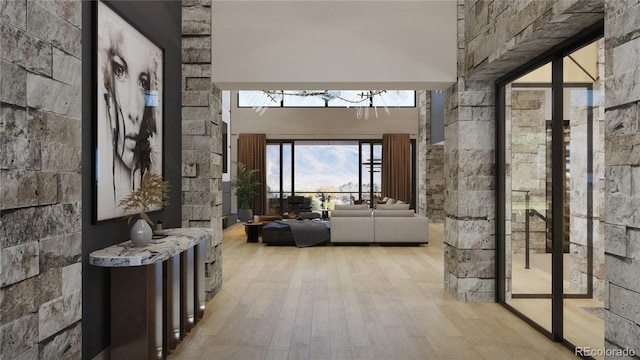 hallway featuring light hardwood / wood-style flooring and a high ceiling