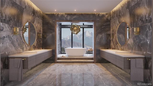 bathroom featuring a notable chandelier, vanity, tile walls, and a tub