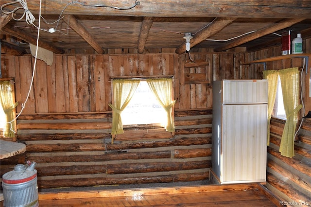 miscellaneous room featuring wooden ceiling, beamed ceiling, and log walls