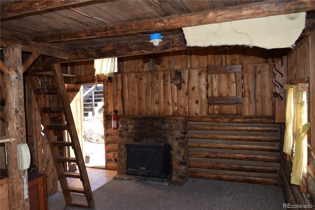 unfurnished living room with carpet floors, wood ceiling, and beam ceiling