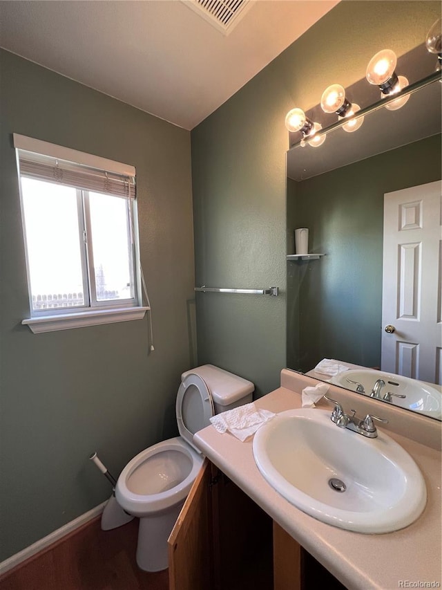 bathroom with vanity and toilet