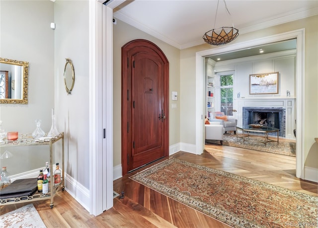 foyer entrance featuring hardwood / wood-style flooring and ornamental molding