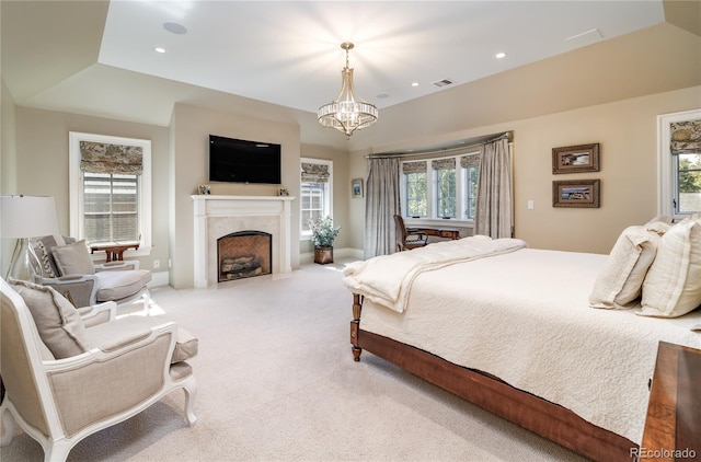 carpeted bedroom with lofted ceiling, an inviting chandelier, and a tray ceiling