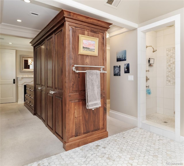 interior space with ornamental molding and tiled shower