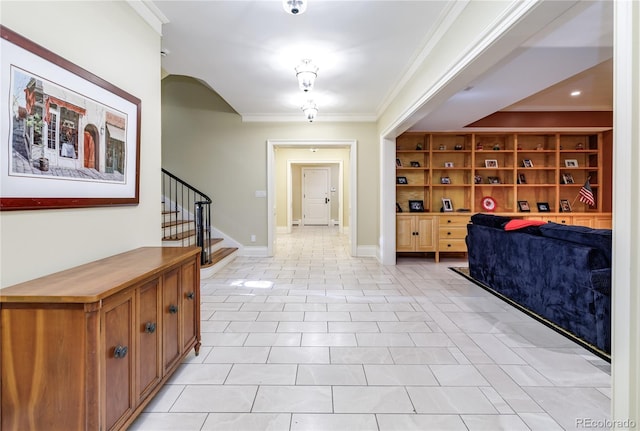 tiled foyer featuring ornamental molding