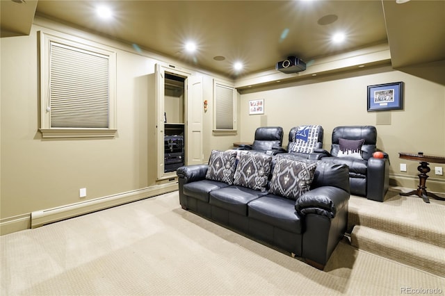 carpeted home theater with a baseboard heating unit