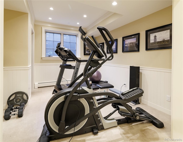 exercise area featuring crown molding and a tray ceiling