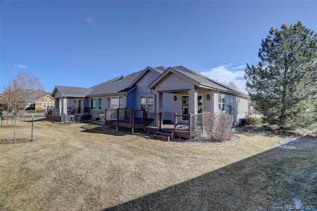 back of house featuring central air condition unit, a yard, and a wooden deck