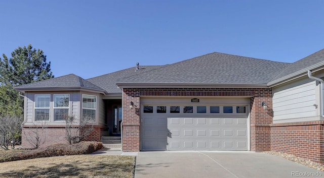 view of front facade with a garage, concrete driveway, brick siding, and a shingled roof